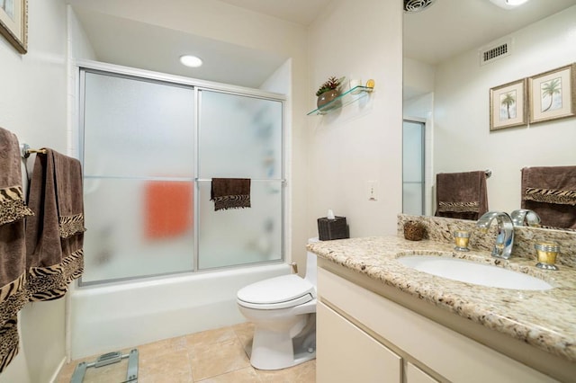 full bathroom featuring tile patterned flooring, combined bath / shower with glass door, vanity, and toilet