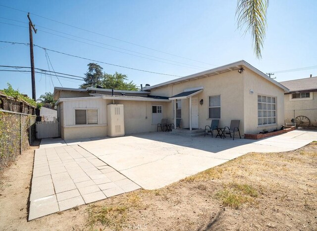 rear view of property featuring a patio area