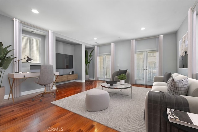 living room featuring baseboards, french doors, wood finished floors, and recessed lighting