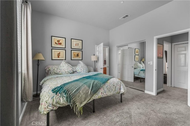 bedroom featuring a closet, carpet flooring, visible vents, and baseboards