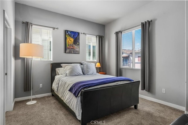 carpeted bedroom featuring baseboards