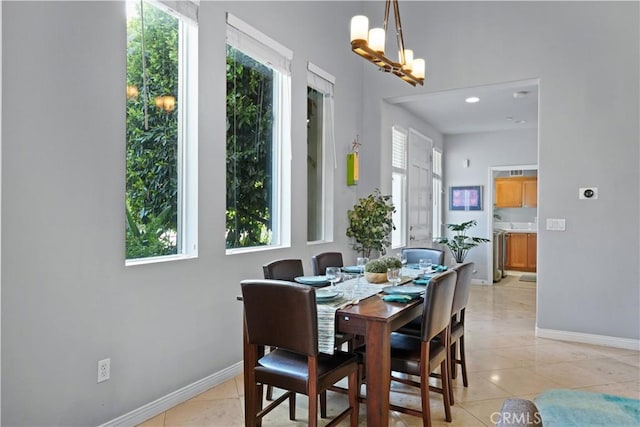 dining space with baseboards, a wealth of natural light, and light tile patterned flooring