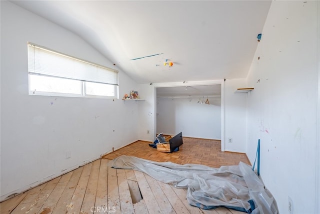 interior space featuring hardwood / wood-style floors and lofted ceiling