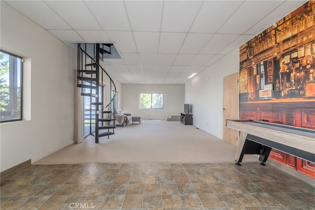 playroom with a drop ceiling and carpet