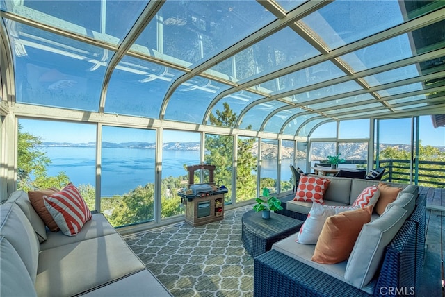 sunroom / solarium featuring a water view and a healthy amount of sunlight