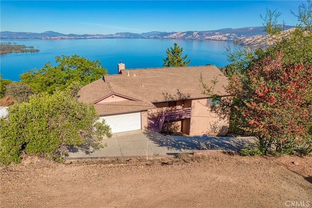 aerial view featuring a water and mountain view