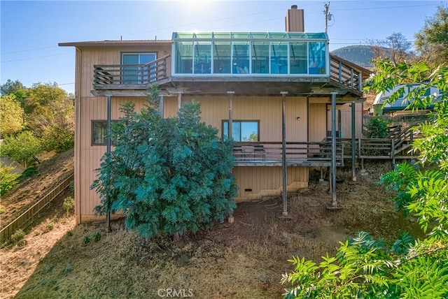 back of property with a balcony