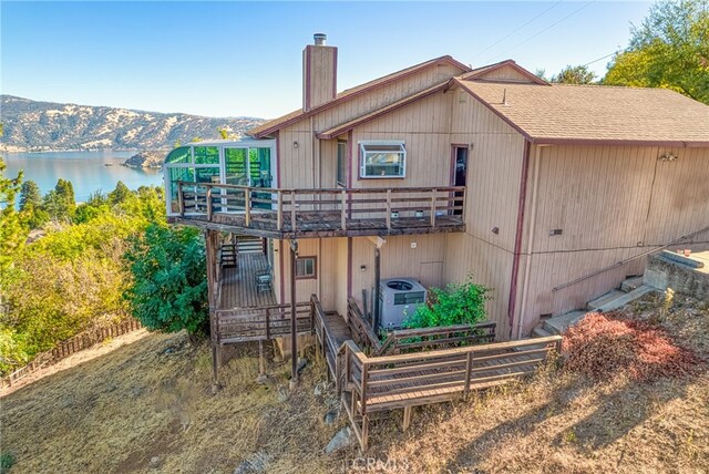 back of house featuring a deck with water view