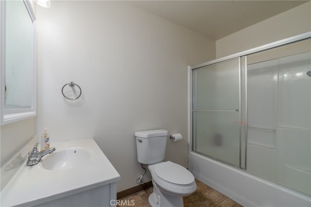 full bathroom with enclosed tub / shower combo, vanity, toilet, and tile patterned floors