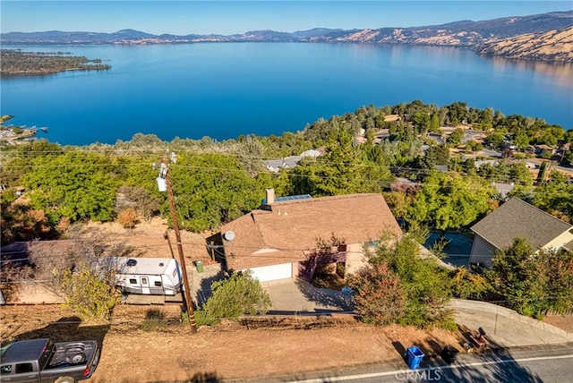 drone / aerial view featuring a water and mountain view