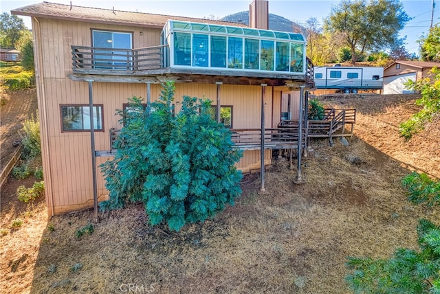 rear view of property with a balcony