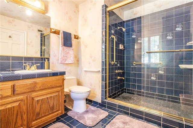 bathroom featuring an enclosed shower, tile patterned flooring, vanity, tasteful backsplash, and toilet