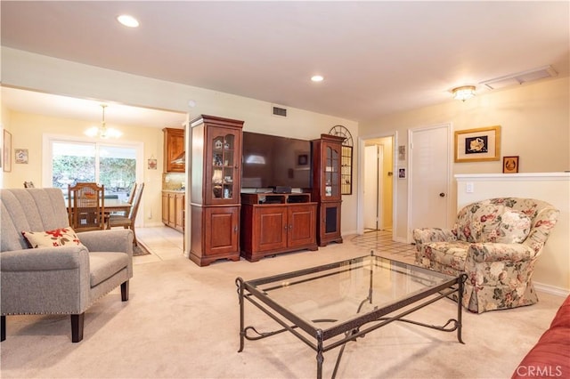 living room with light colored carpet and an inviting chandelier