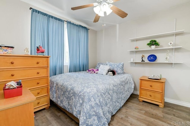 bedroom with wood-type flooring and ceiling fan