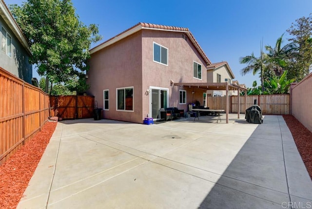 rear view of property featuring a patio area