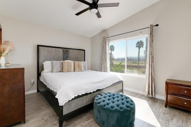 bedroom featuring ceiling fan, vaulted ceiling, and light hardwood / wood-style flooring