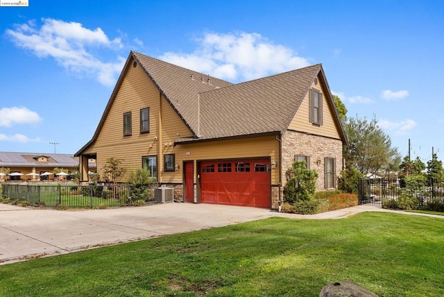 view of front of house featuring a garage, a front lawn, and central AC unit