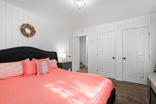 bedroom with dark colored carpet