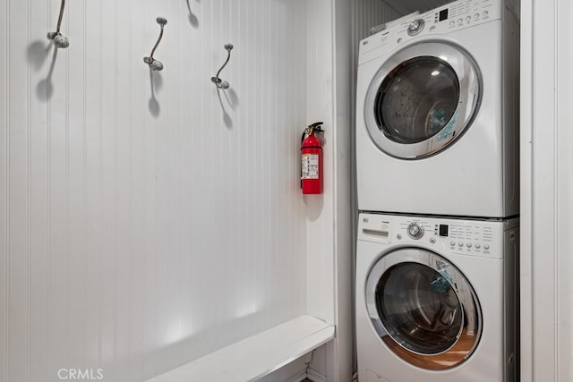 washroom featuring stacked washer / dryer