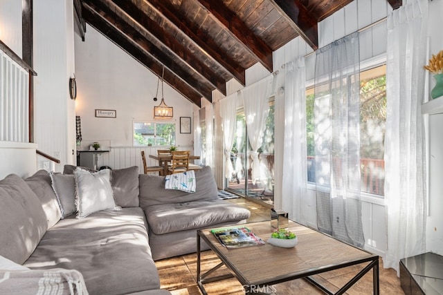 living room with high vaulted ceiling, beamed ceiling, a wealth of natural light, and wooden ceiling