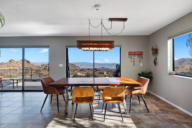 dining area featuring a notable chandelier and a mountain view