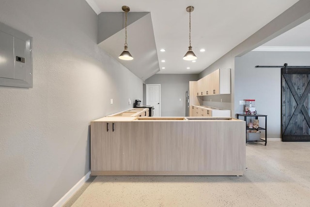 kitchen with light brown cabinets, hanging light fixtures, a barn door, electric panel, and ornamental molding