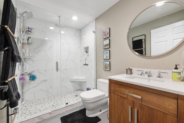 bathroom with vanity, toilet, and a shower with shower door