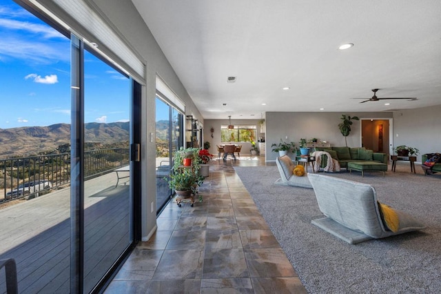 interior space with a mountain view and ceiling fan