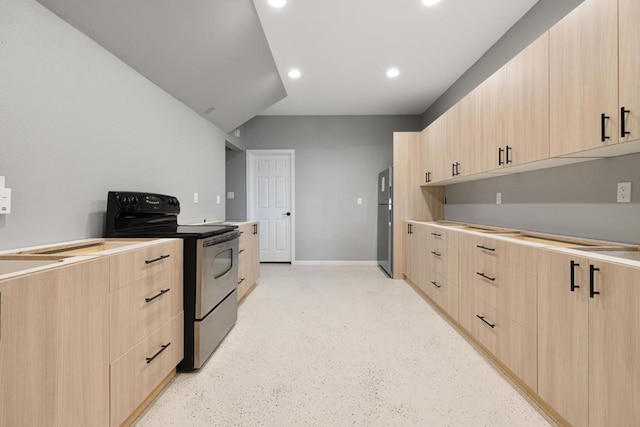 kitchen with stainless steel refrigerator, black range with electric stovetop, and light brown cabinetry