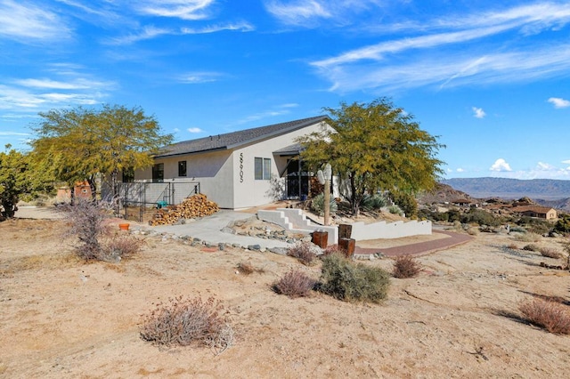 rear view of property featuring a mountain view