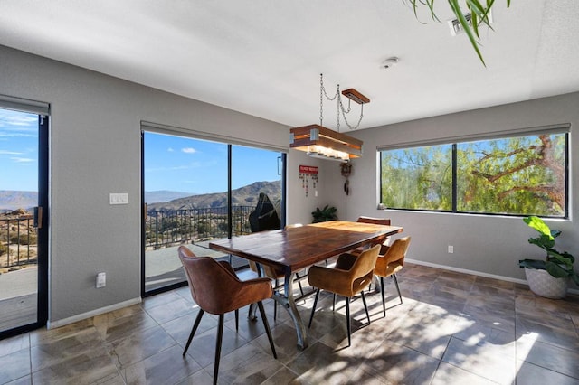 dining room featuring a mountain view