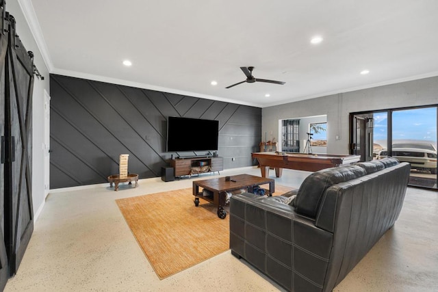 living room with a barn door, ceiling fan, crown molding, and pool table