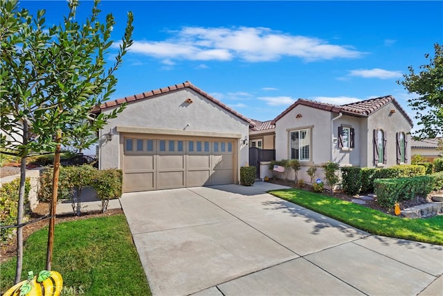 mediterranean / spanish-style home with a front lawn and a garage