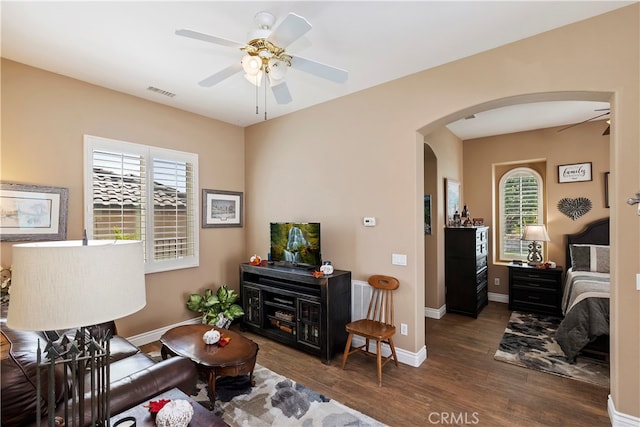 living room with ceiling fan, plenty of natural light, and dark hardwood / wood-style floors