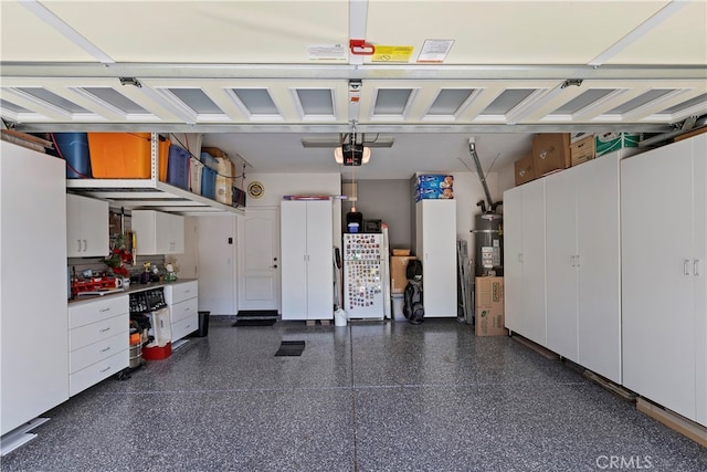 garage featuring a garage door opener and strapped water heater