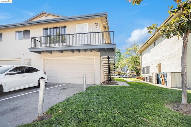 view of front of house with a garage, a balcony, and a front yard