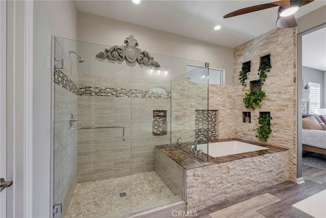 bathroom with independent shower and bath, ceiling fan, and wood-type flooring