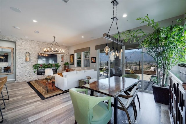 dining space with a chandelier and light hardwood / wood-style flooring