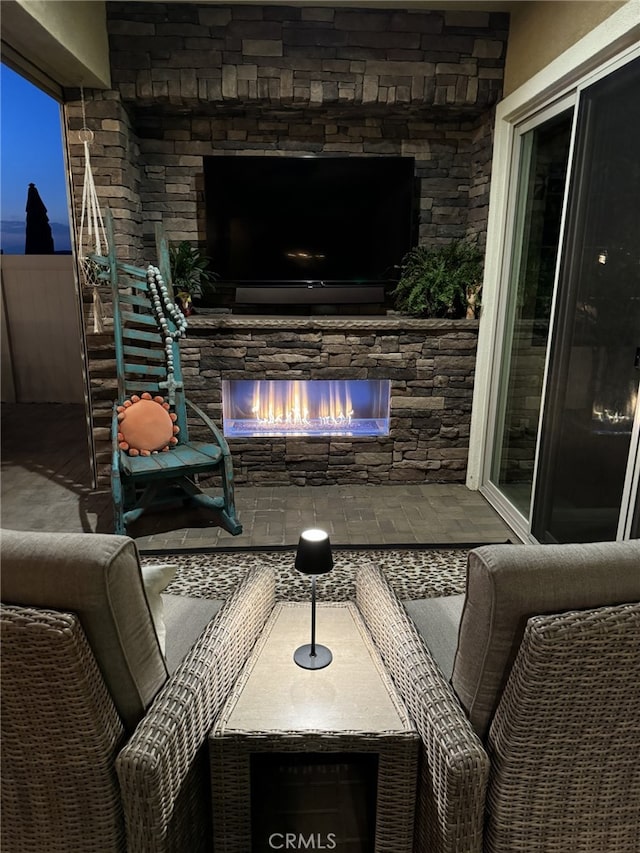 view of patio with an outdoor stone fireplace