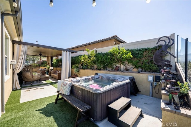 view of patio with an outdoor hangout area, ceiling fan, and a hot tub