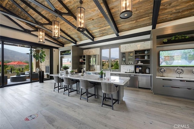 kitchen with wood ceiling, lofted ceiling with beams, decorative light fixtures, gray cabinets, and a large island