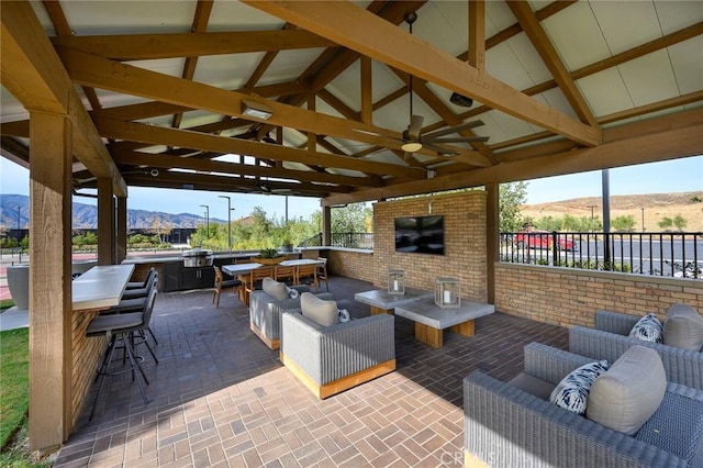 view of patio featuring a gazebo, an outdoor living space, and a bar