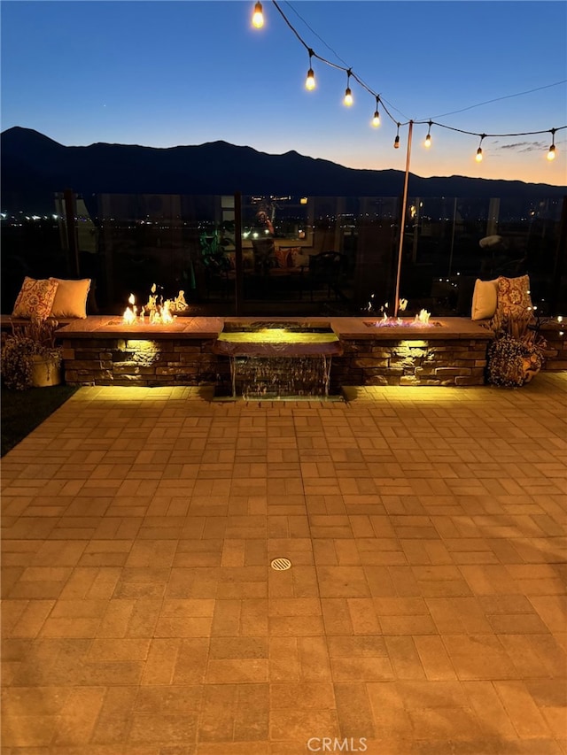 patio terrace at dusk with a mountain view