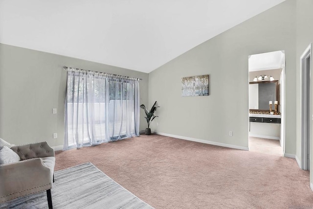 carpeted living room featuring high vaulted ceiling