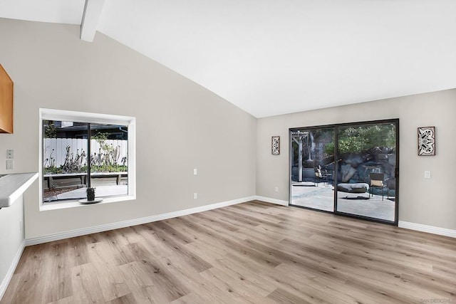 unfurnished living room with light hardwood / wood-style flooring, beam ceiling, and high vaulted ceiling