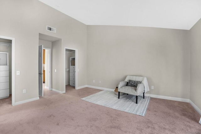 living area featuring high vaulted ceiling and light colored carpet