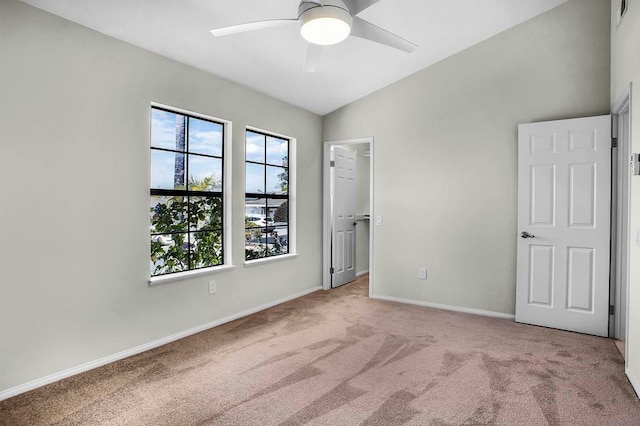 unfurnished bedroom with ceiling fan, a closet, carpet, and a spacious closet