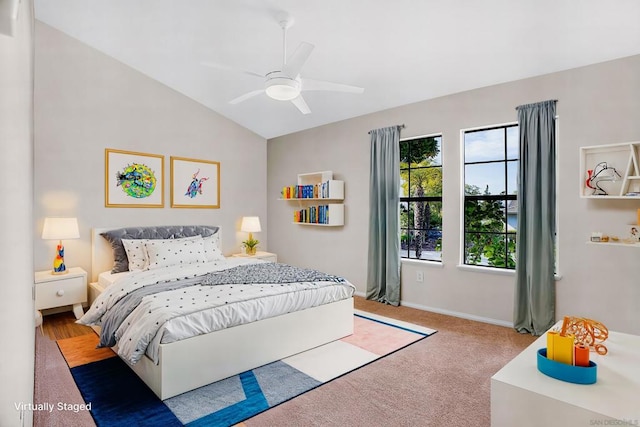 carpeted bedroom featuring ceiling fan and vaulted ceiling