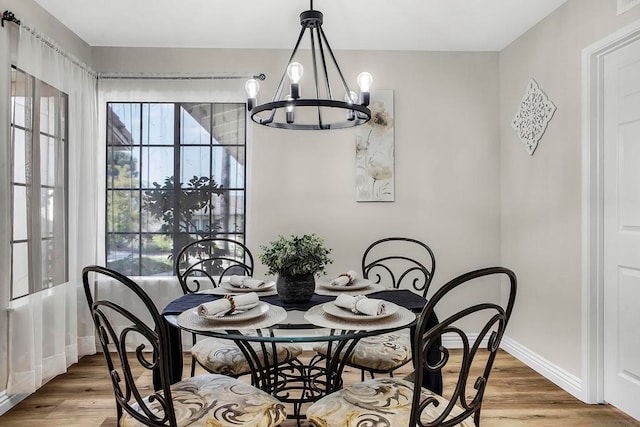 dining room featuring hardwood / wood-style flooring and a notable chandelier