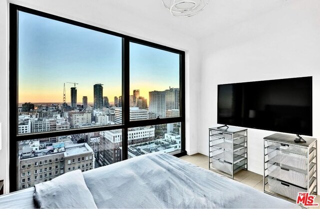 bedroom with light wood-type flooring and floor to ceiling windows